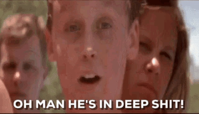 a man and a woman are standing next to each other and the man is saying `` oh man he 's in deep shit '' .