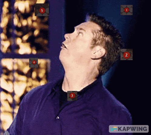 a man in a purple shirt is looking up at a screen that says kapwing at the bottom