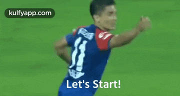 a soccer player is standing on a field with his arms outstretched .