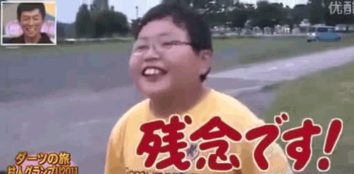 a young boy wearing glasses and a yellow shirt is smiling in front of a sign that says !