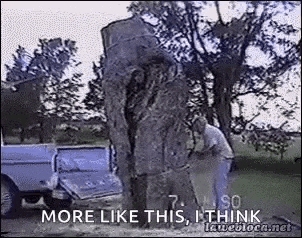 a man is cutting down a tree with a chainsaw in a yard .
