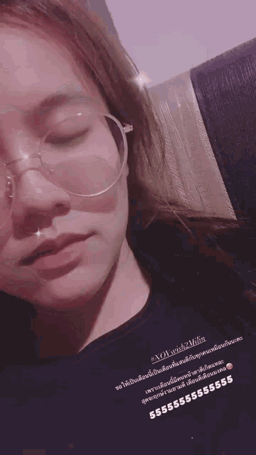 a close up of a woman wearing glasses and a black shirt with a purple background