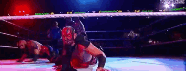 a wrestling match is being played in a ring with a sign that says the nextclothing