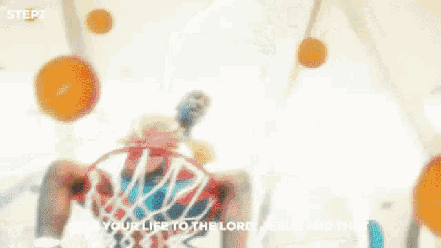 a man is sitting in front of a basketball hoop with the words give your life to the lord jesus and that above him