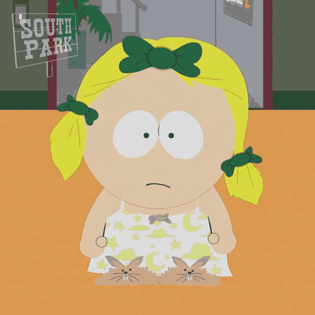 a cartoon girl with bunny slippers is sitting in front of a south park sign