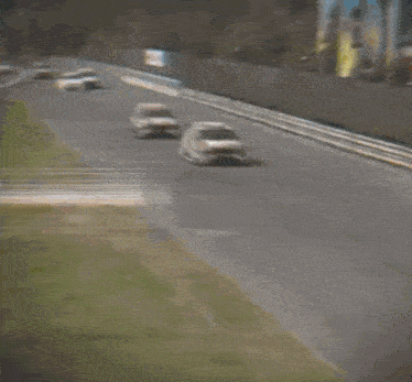 a blurred image of a race car going down a road