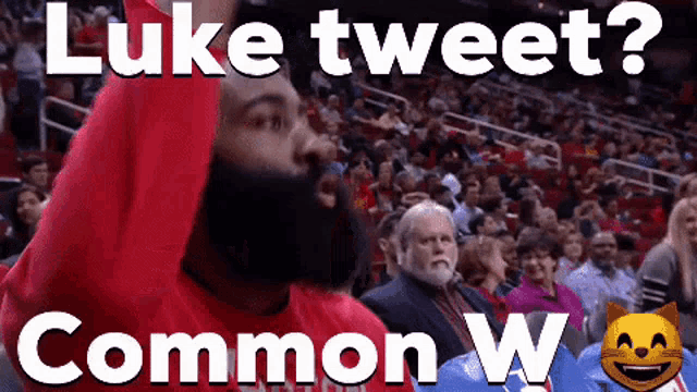 a man with a beard is sitting in the stands with his arms in the air and the words luke tweet common w.