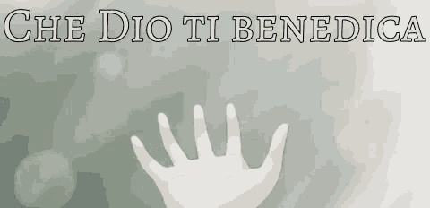 a hand with white paint on it is reaching out towards the word che dio ti benedica