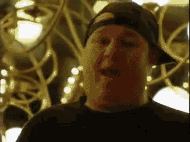 a man wearing a hat and a black shirt
