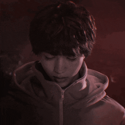 a close up of a person 's face with a hood on