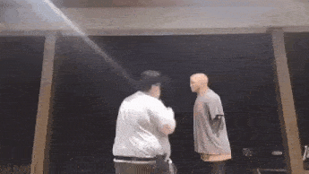 a man and a mannequin are standing next to each other on a stage .