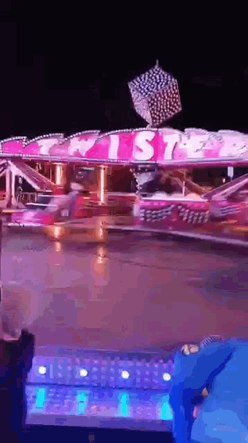a pink carnival ride that says twister on it
