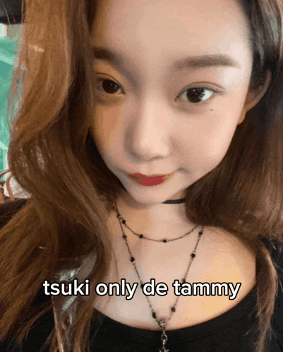 a close up of a woman 's face with the words tsuki only de tammy below her