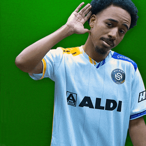 a man wearing a blue and white shirt that says aldi