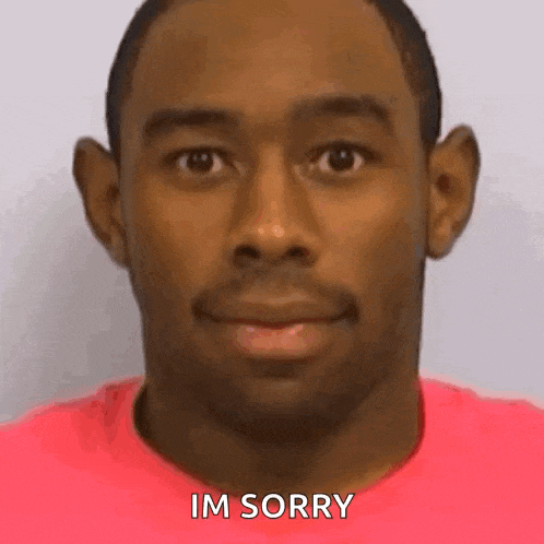 a close up of a man 's face with the words `` im sorry '' written on it .