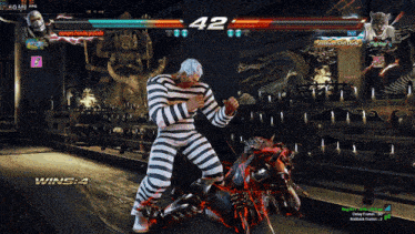 a man in striped pants is fighting another man in a video game with the score 42