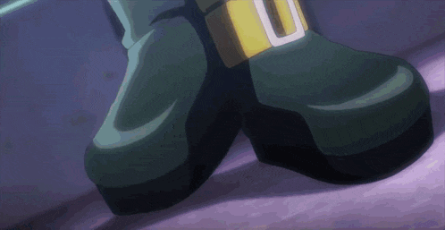 a close up of a person 's feet with a buckle that has the letter u on it