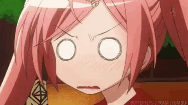 a girl with pink hair is making a funny face .
