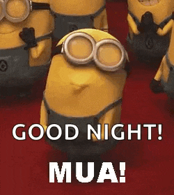 a group of minions standing next to each other on a red carpet .