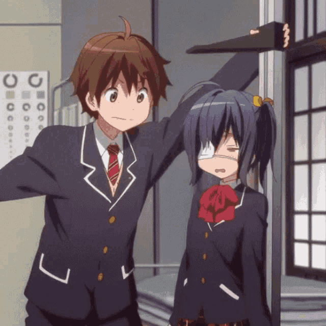 a boy and a girl are standing next to each other in front of a sign that says o on it