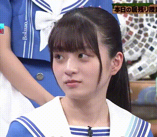 a girl in a blue and white sailor outfit is looking at something