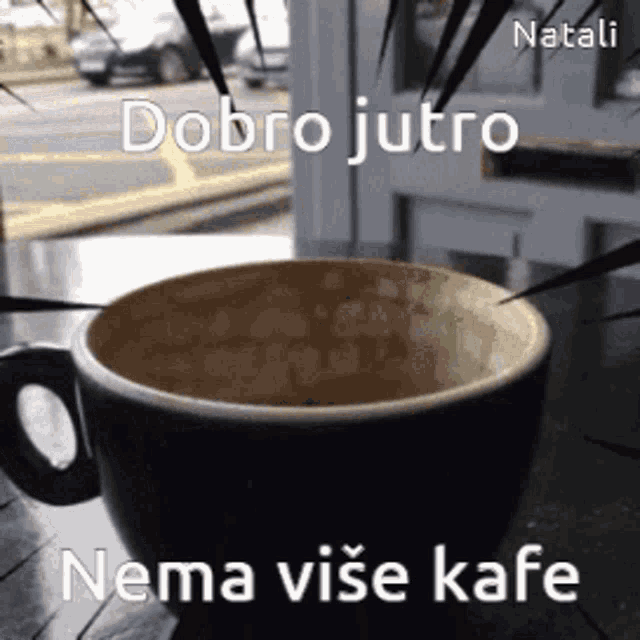 a cup of coffee on a table with the words " dobro jutro nema vise kafe " on the bottom