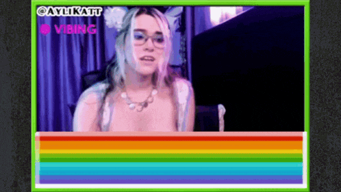 a woman with glasses is sitting in front of a computer screen with a rainbow border and the words aylikatt vibing