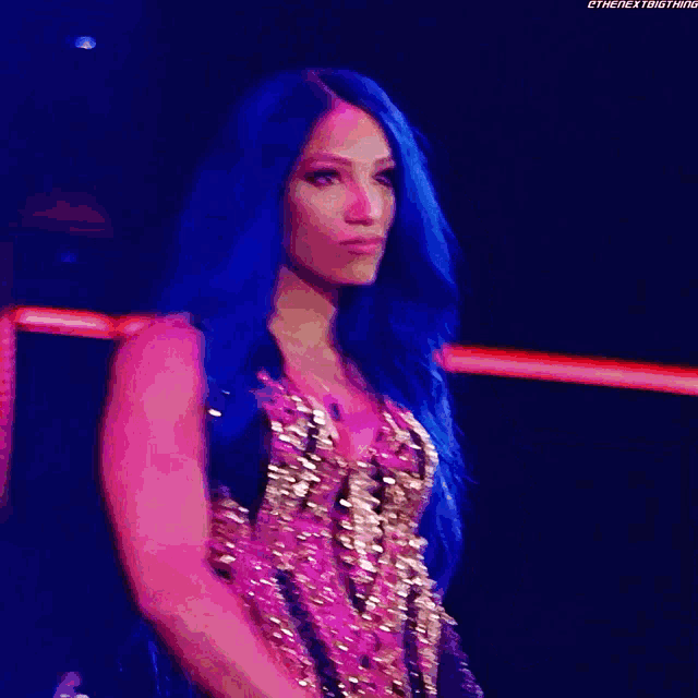 a woman with long blue hair is wearing a sequined top