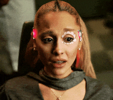 a woman has a flower painted on her eye