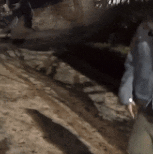 a person walking down a dirt road with a backpack