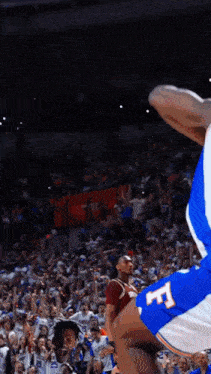 a basketball player wearing a blue jersey with the letter f on the back