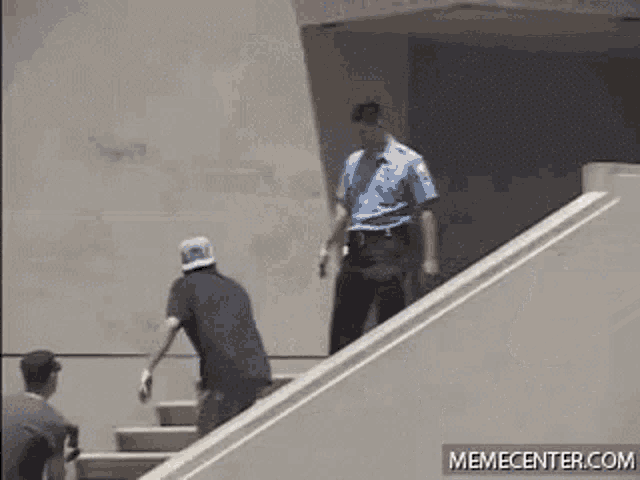 a man is skateboarding down a set of stairs while two other men watch .