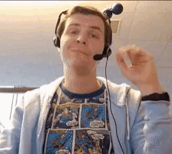 a man wearing headphones and a comic book t-shirt with the word spiderman on it