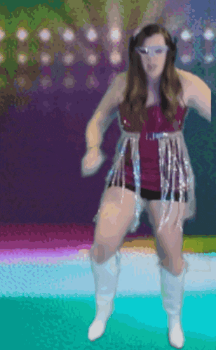 a woman in a purple dress and white boots dancing