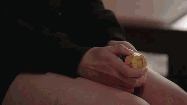 a person is holding a toy in their hands with the letter c on it
