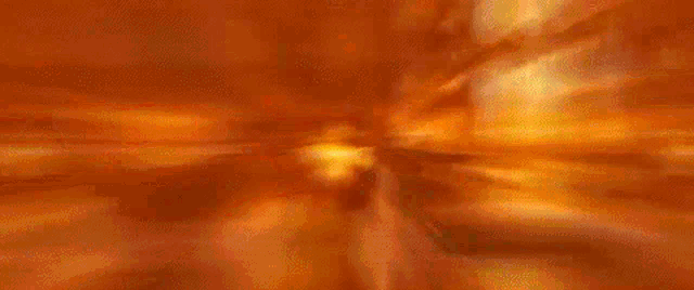 a blurry picture of a race car driving down a track .