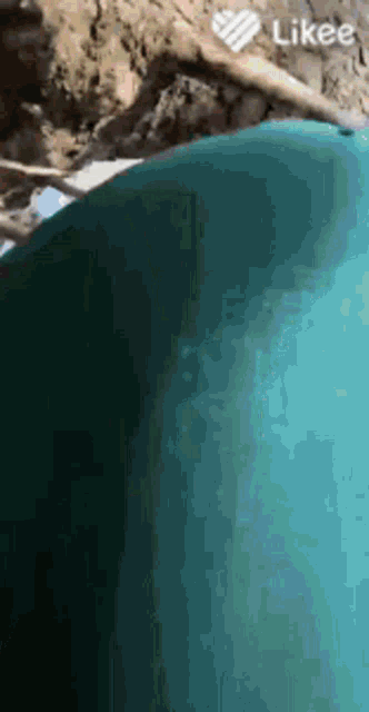 a person is swimming in a pool with a likee logo in the background .