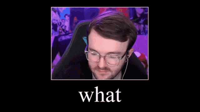 a man wearing glasses and ear buds is sitting in a chair with the word what above him .