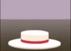 a white hat with a red ribbon around the brim is sitting on a table .