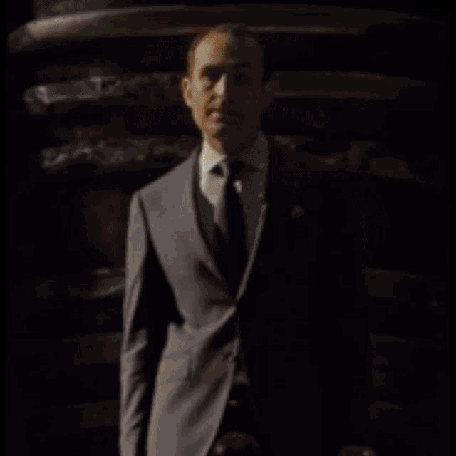 a man in a suit and tie is behind a hamburger