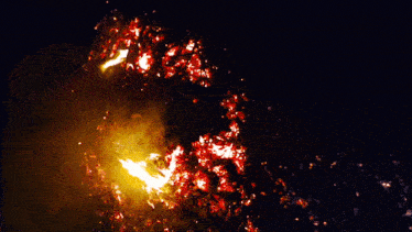 a fire is burning in the dark with a lot of smoke