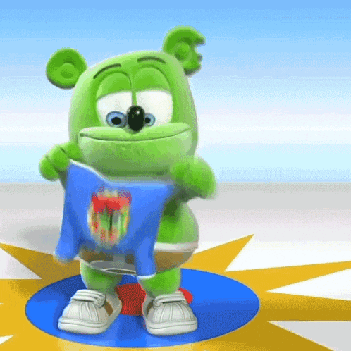 a green gummy bear is holding a blue shirt that says ' gummy bear ' on it