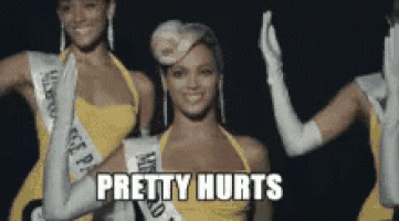 a woman in a yellow dress with the words pretty hurts on the bottom