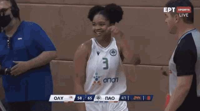 a basketball player wearing a number 3 jersey is shaking hands with another player