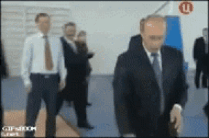 a blurry picture of a man in a suit and tie walking in a room