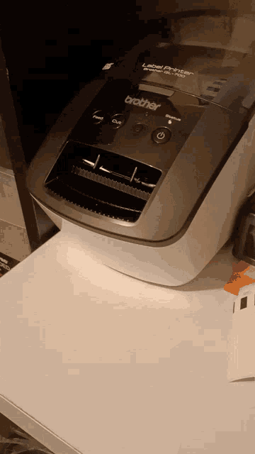 a brother label printer sits on a white counter