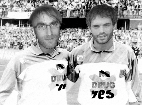 two men are standing next to each other and one has a shirt that says drug yes