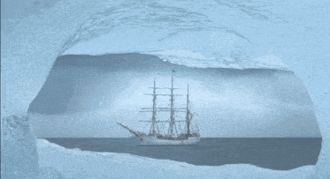 a ship in the ocean with a flag on the mast