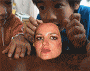 a pixelated image of a woman 's face being touched by two boys