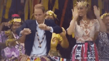 a man and a woman are dancing in front of a crowd while wearing hawaiian costumes .